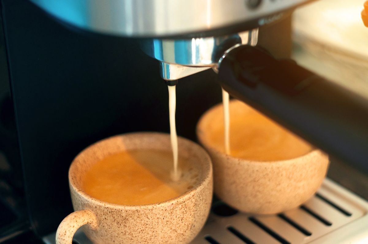 Coffee machine. Close-up of espresso pouring from coffee machine. Professional coffee brewing
